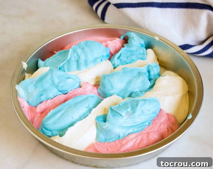 Patriotic Swirl No-Churn Delight 4 A pan filled with distinct stripes of red, white, and blue ice cream mixture, ready to be frozen.