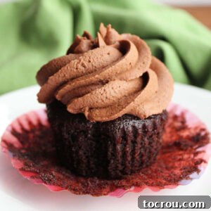 Crazy Delicious Chocolate Cupcakes 9 Chocolate cupcake with the wrapped peeled down showing the moist deep chocolate cake, topped with chocolate condensed milk buttercream frosting swirl.