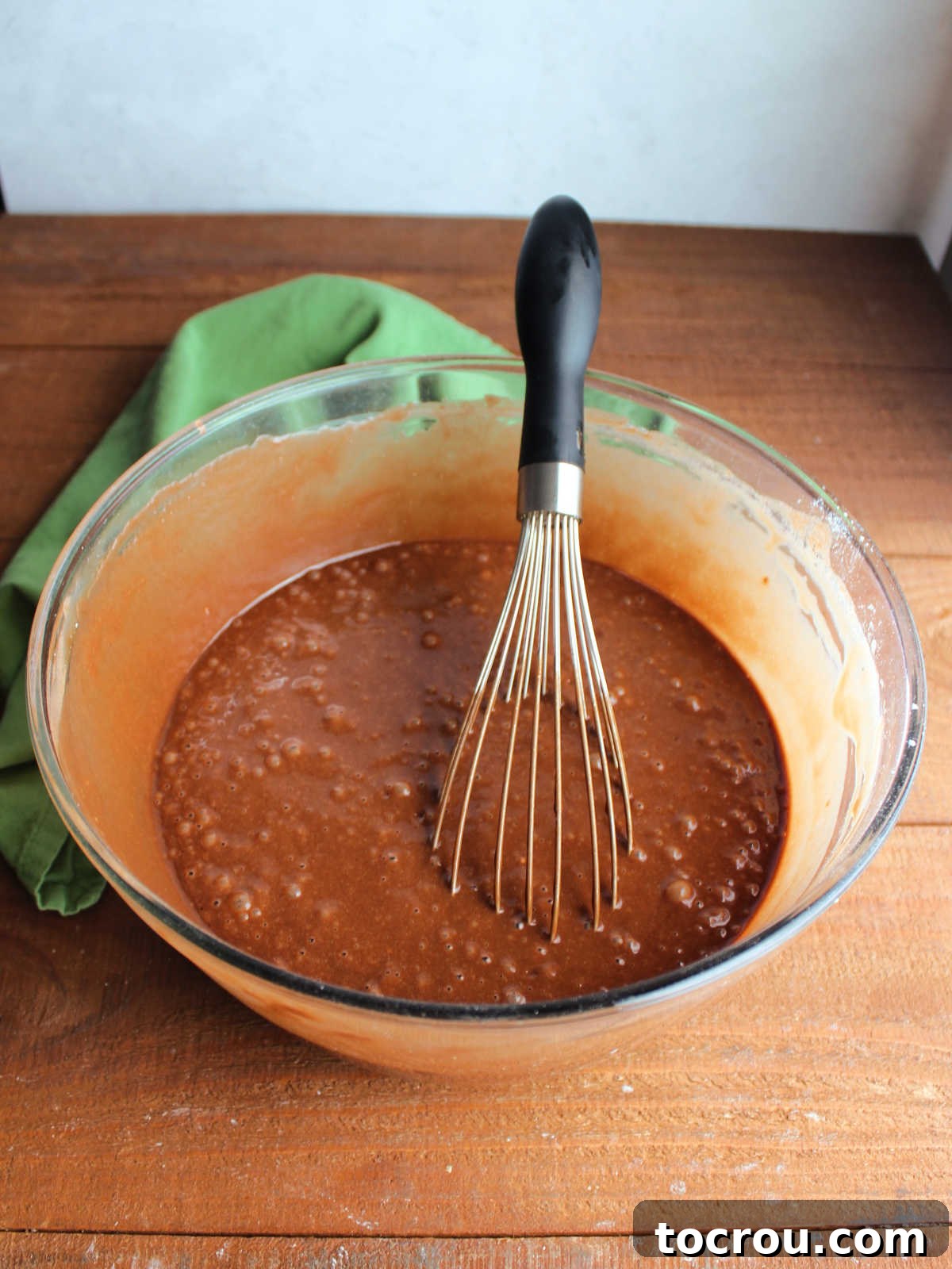 Crazy Delicious Chocolate Cupcakes 3 Mixing bowl and whisk with chocolate crazy cake batter inside.