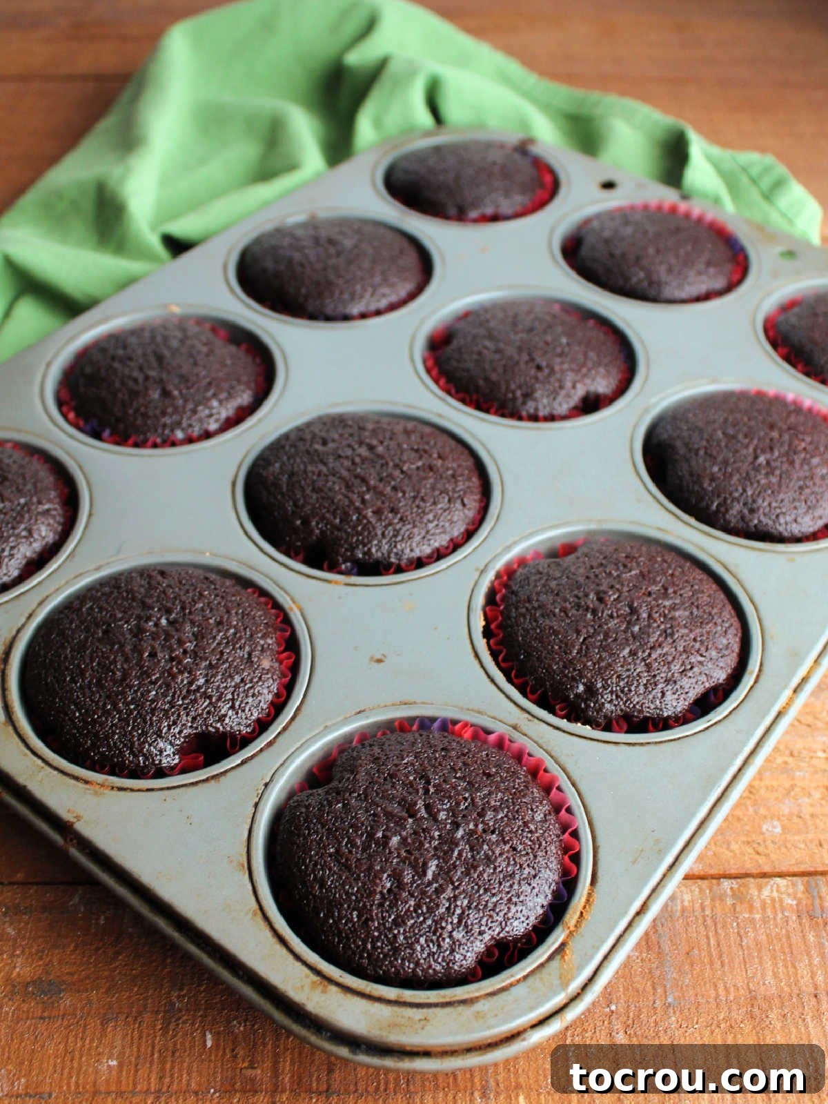 Crazy Delicious Chocolate Cupcakes 5 Tin of baked chocolate cupcakes showing dark chocolate color and slightly domed tops.