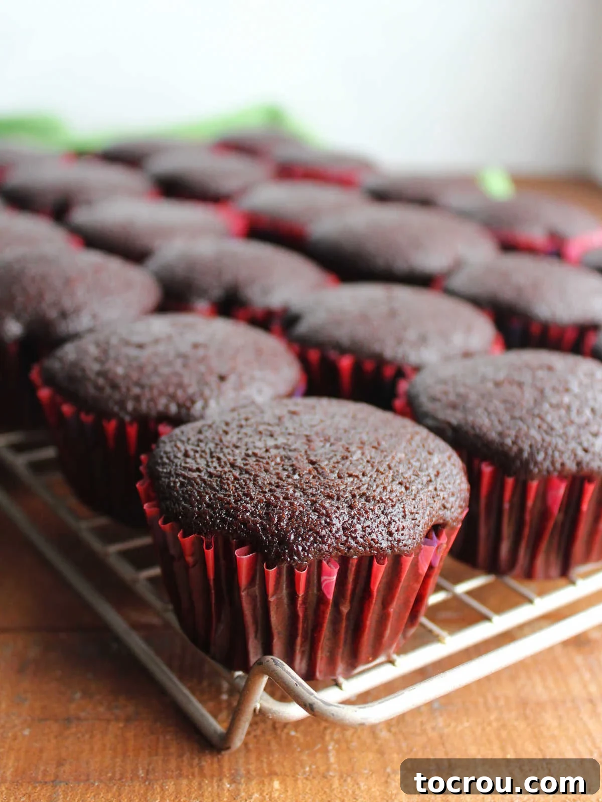 Crazy Delicious Chocolate Cupcakes 6 Chocolate crazy cake cupcakes on wire cooling rack, waiting for frosting.