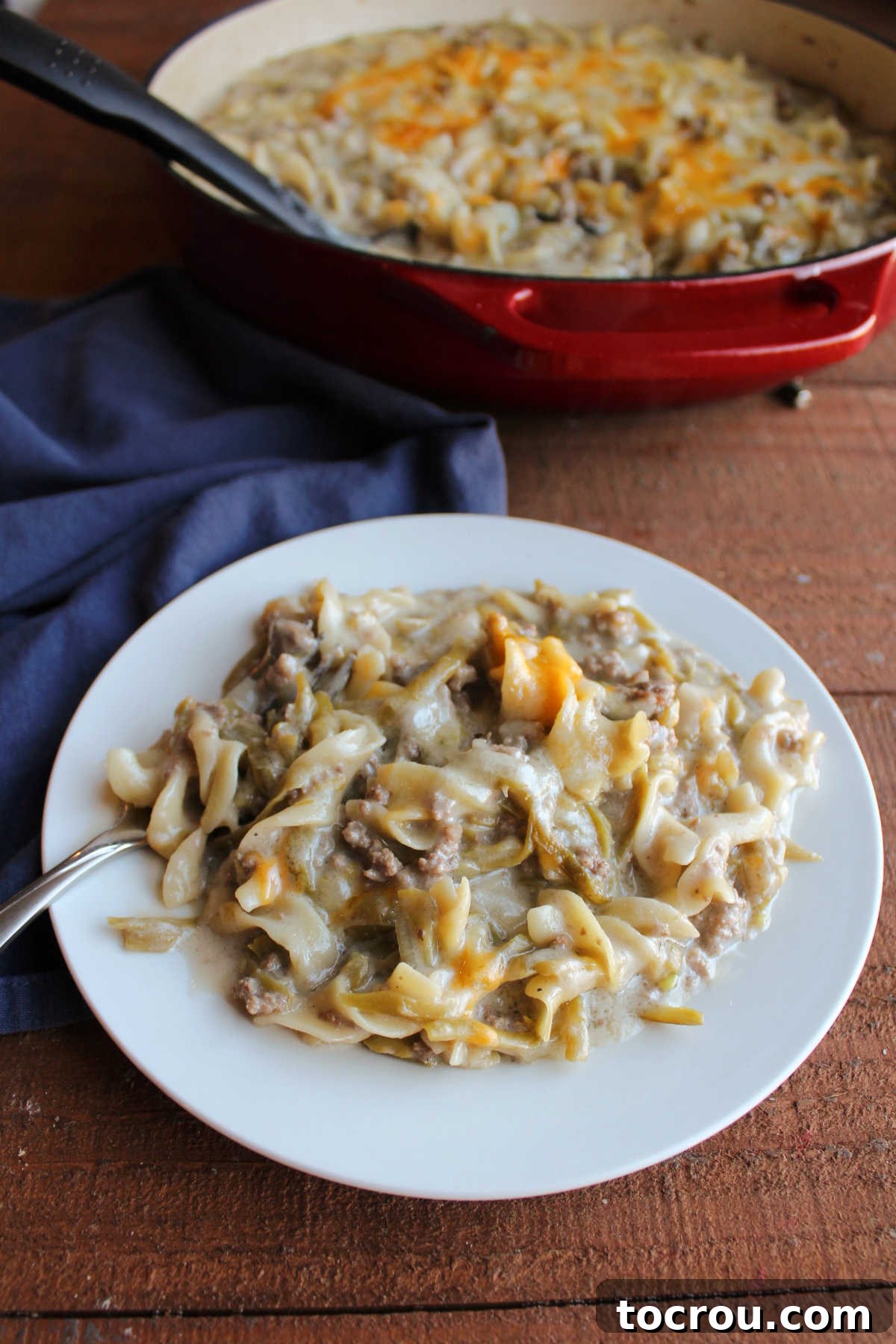 Plate of one pot hot dish with pasta, ground beef, and green beans, ready to eat.