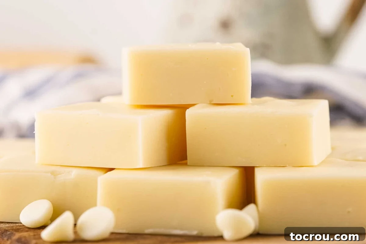 A beautiful pyramid of homemade vanilla fudge squares, garnished with scattered white chocolate chips, tempting every sweet tooth.