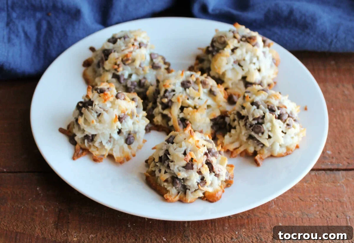 Maw-Maw's Delightful Almond Joy Macaroons 2 Platter of almond joy cookies with coconut, chocolate chips, and sliced almonds held together by sweetened condensed milk to make cookies.