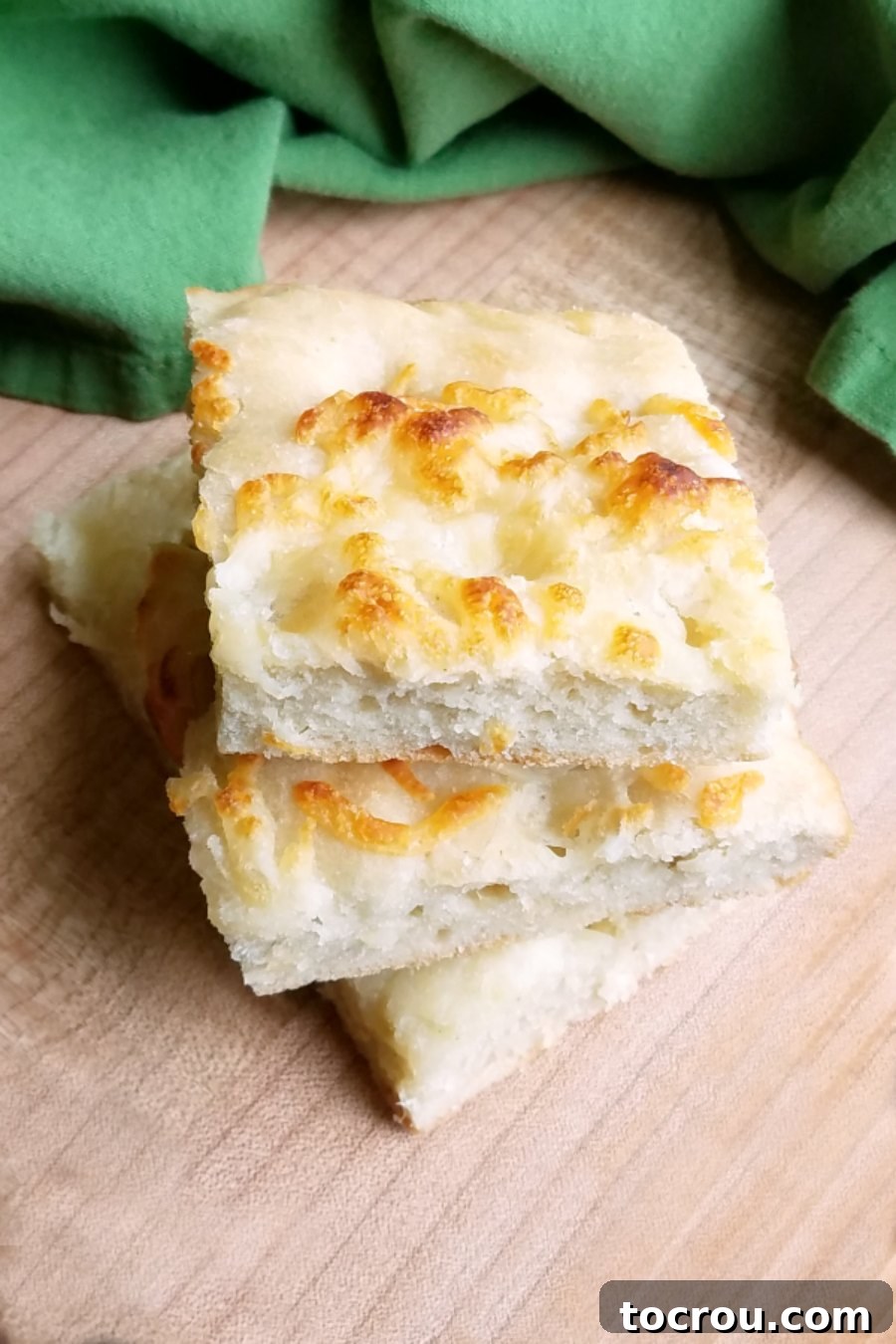 Soft and chewy sourdough foccacia topped with cheese and garlic is the perfect side for any Italian meal. It’s like one big giant bread stick only easier to make!