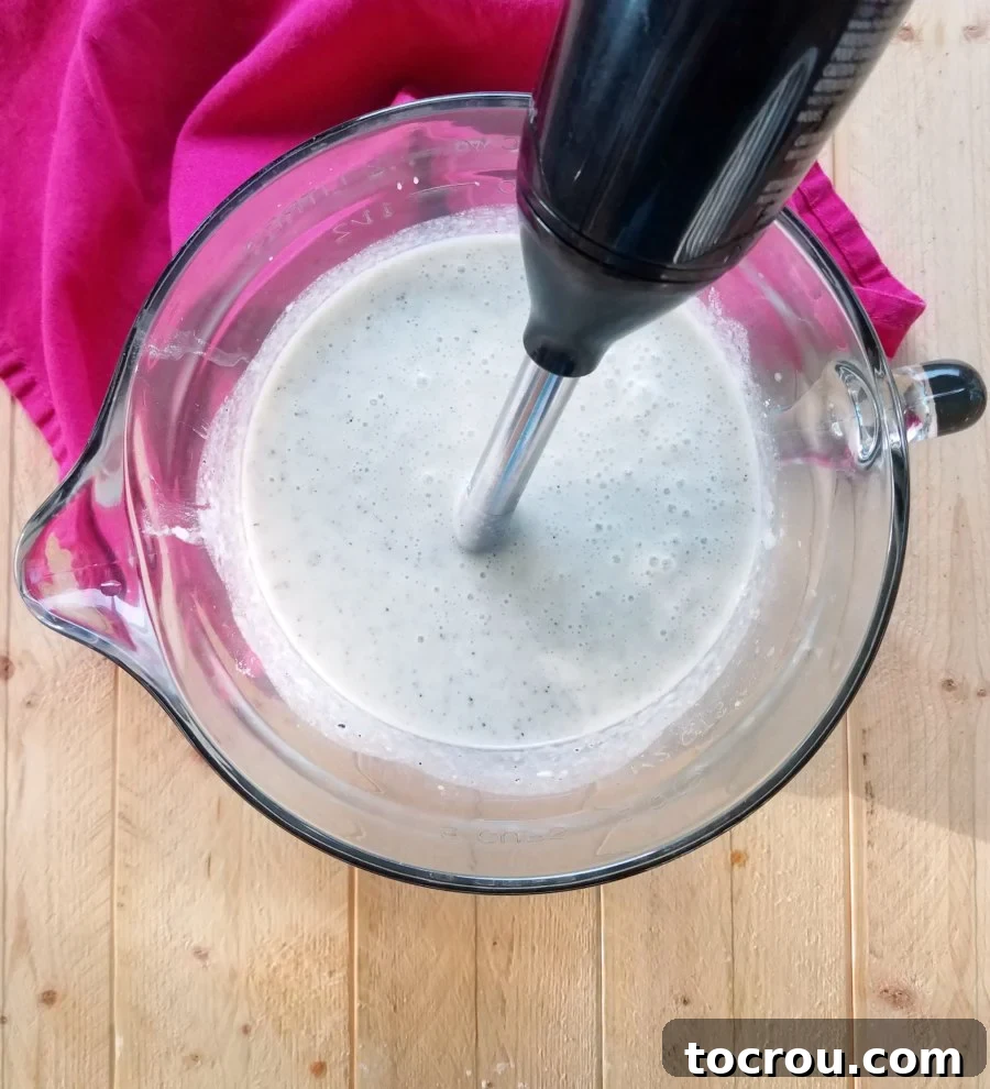 Enchanted Dragonfruit Pie 4 using immersion blender to puree pie batter.