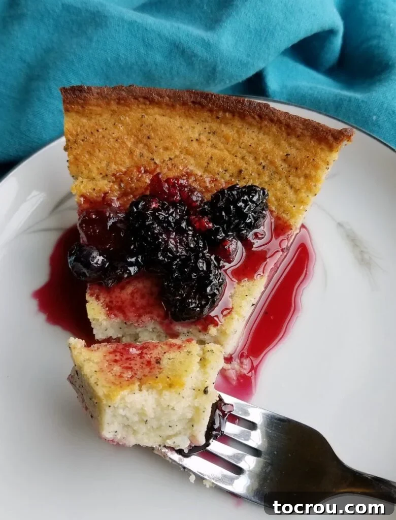 Enchanted Dragonfruit Pie 8 Bite of creamy dragon fruit pie with blackberry sauce on fork ready to eat.