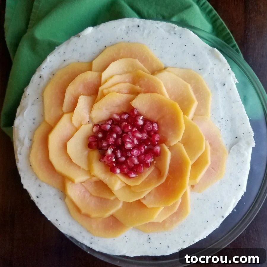 Tropical White Cake with Dragonfruit Buttercream and Blood Orange Curd, topped with fresh papaya and pomegranate.