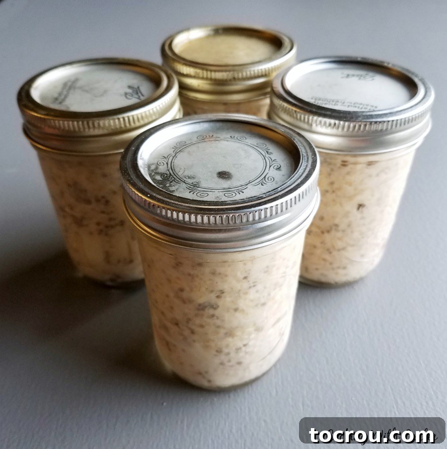 Overnight Oats Ready to Go Jars of peach overnight oatmeal with lids on, ready to grab and go.