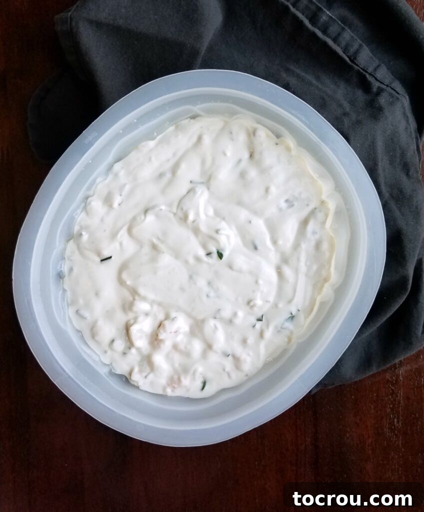 Shrimp dip mixture in a plastic brain mold, chilling to set.