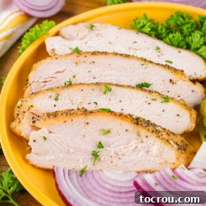 Plate with slices of smoked turkey breast on it, ready to eat.