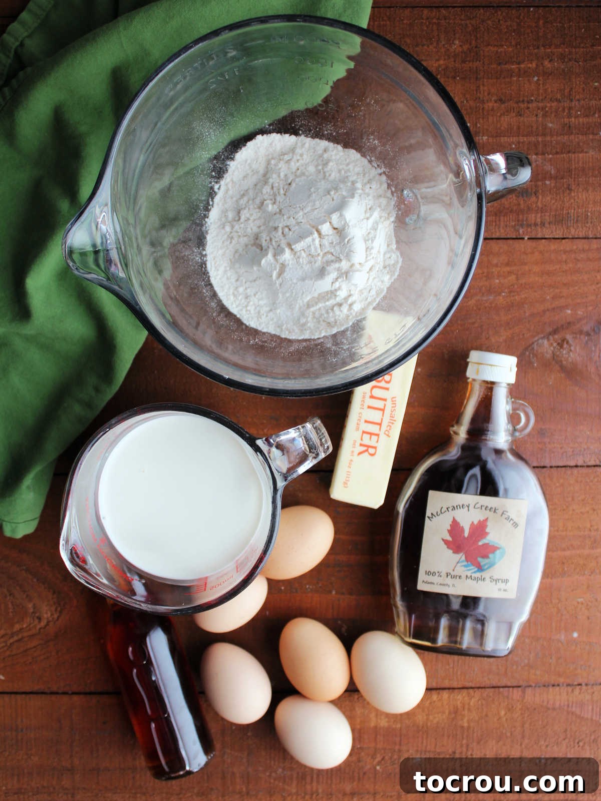 Mimi's Golden Custard Delight 3 Ingredients including flour, salt, milk, vanilla, eggs, butter, and maple syrup ready to be made into a german pancake.