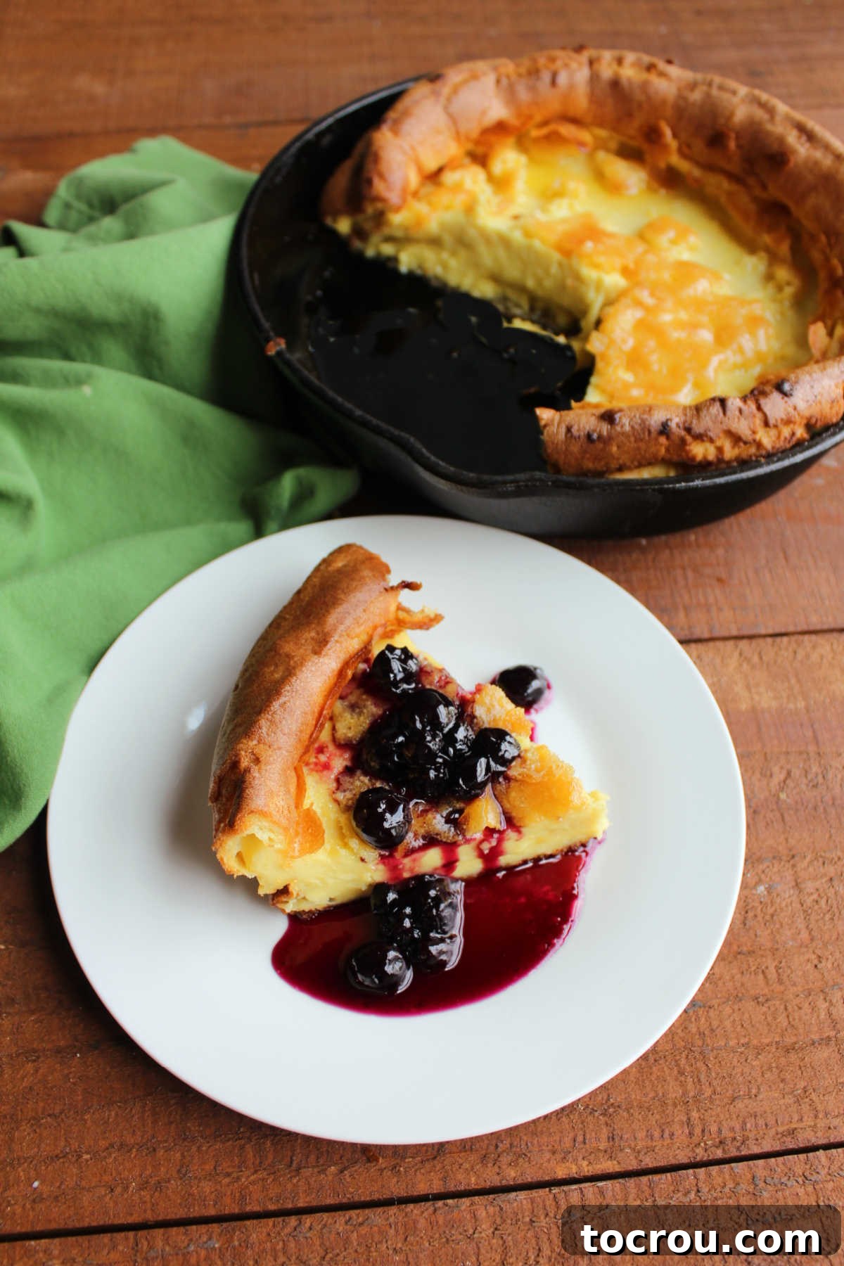 Mimi's Golden Custard Delight 7 Slice of dutch baby pancake served with homemade blueberry syrup.