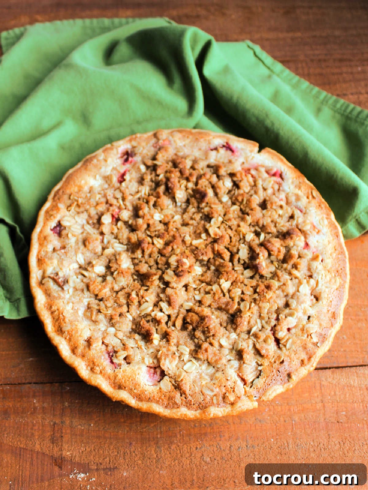 Baked sour cream rhubarb pie with golden brown oat crisp topping.