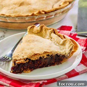 Sliced of cherry rhubarb pie with double crust and thick fruity filling on plate with fork, ready to eat.
