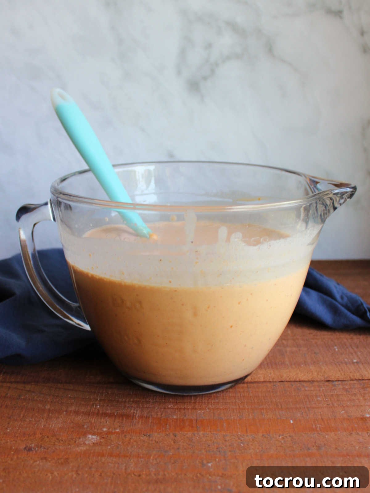Velvet Pumpkin Ice Cream 3 Glass batter bowl with pumpkin ice cream base inside.