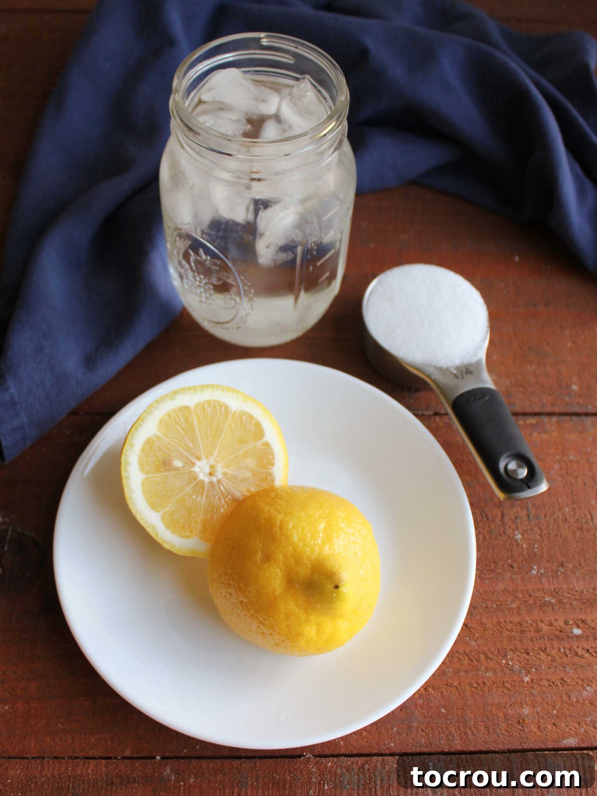 Tangy Shaken Lemonade 3 Ingredients including fresh lemon, sugar, ice, and water ready to be made into lemon shake up.