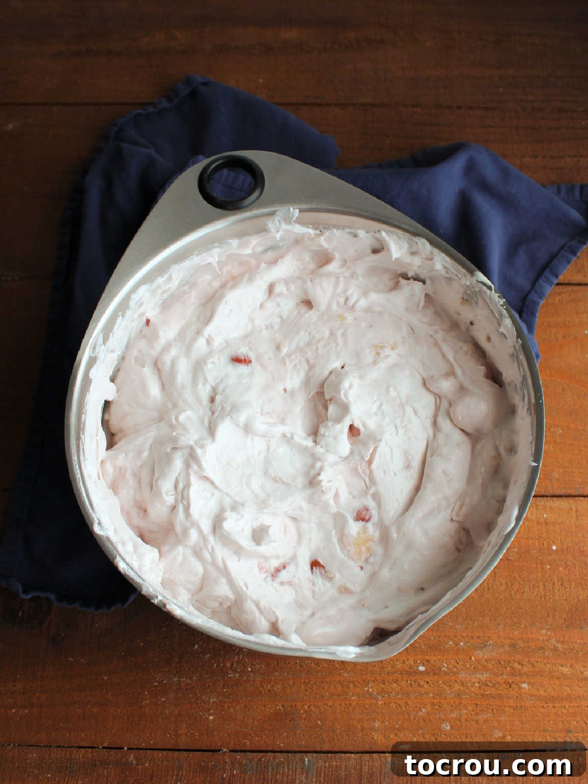 Mixing bowl filled with cherry cheesecake salad, ready to go in the refrigerator to chill and set up.