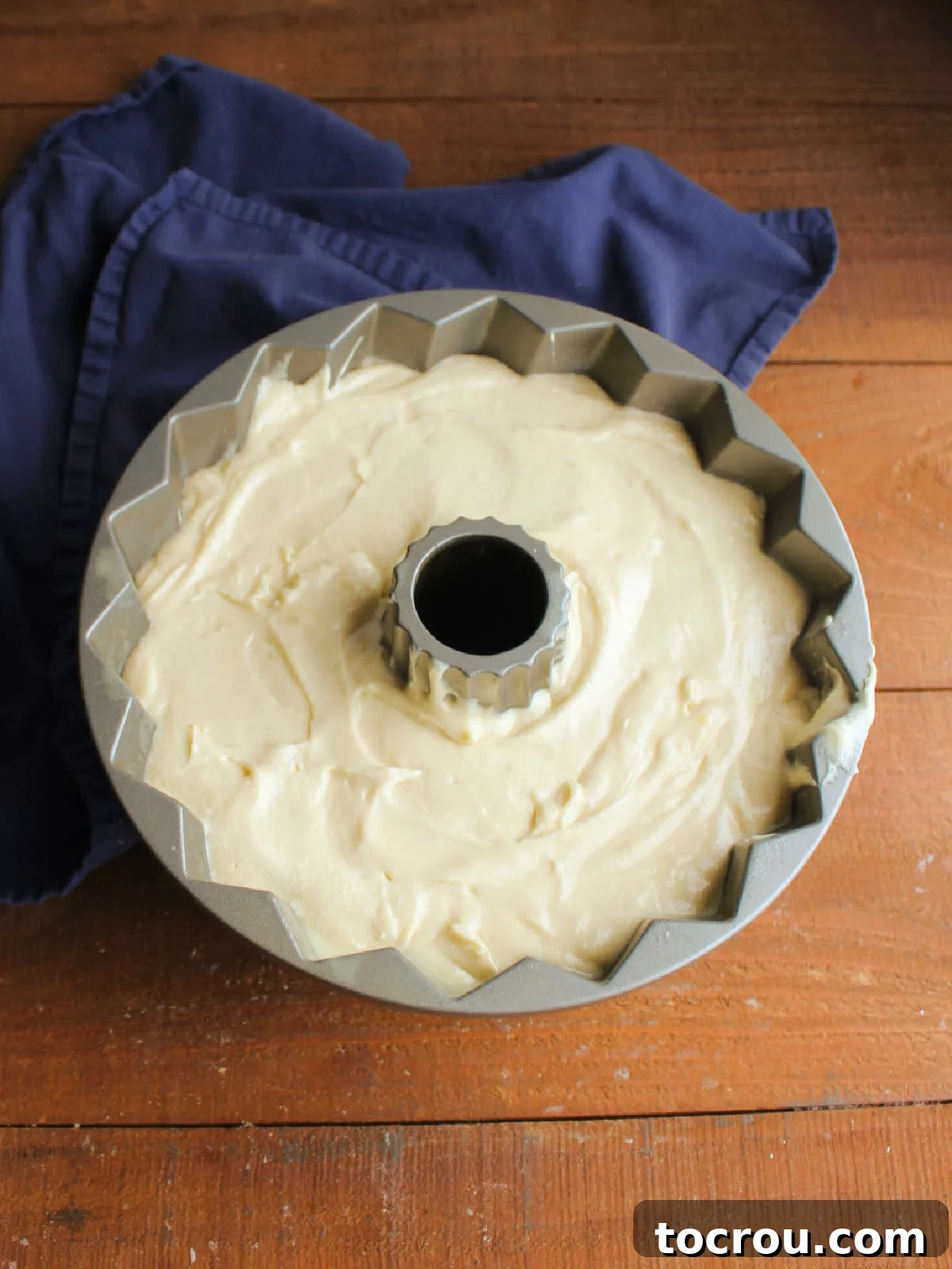 Thick pound cake batter in bundt pan, ready to go in the oven.