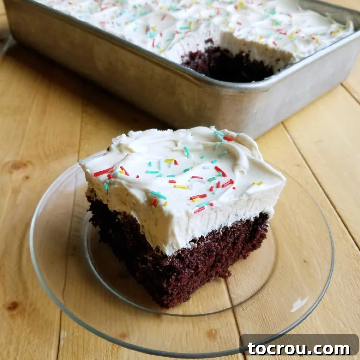 Whipped Sweetened Condensed Milk Frosting on Chocolate Cake Piece of chocolate cake generously topped with fluffy white whipped sweetened condensed milk frosting.