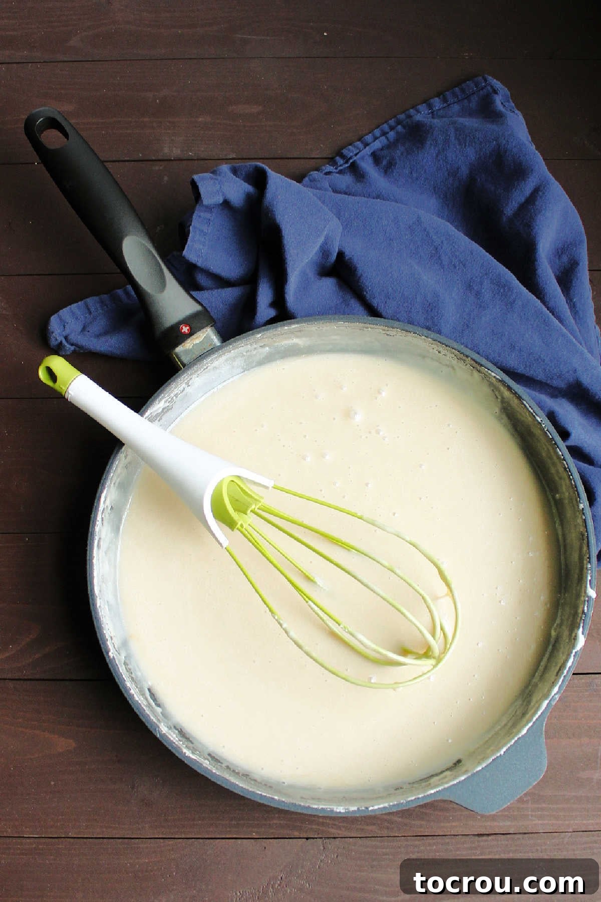 Cooking the Condensed Milk Mixture Sweetened condensed milk mixture with flour and sugar heating in a saucepan, ready to be chilled and transformed into fluffy frosting.