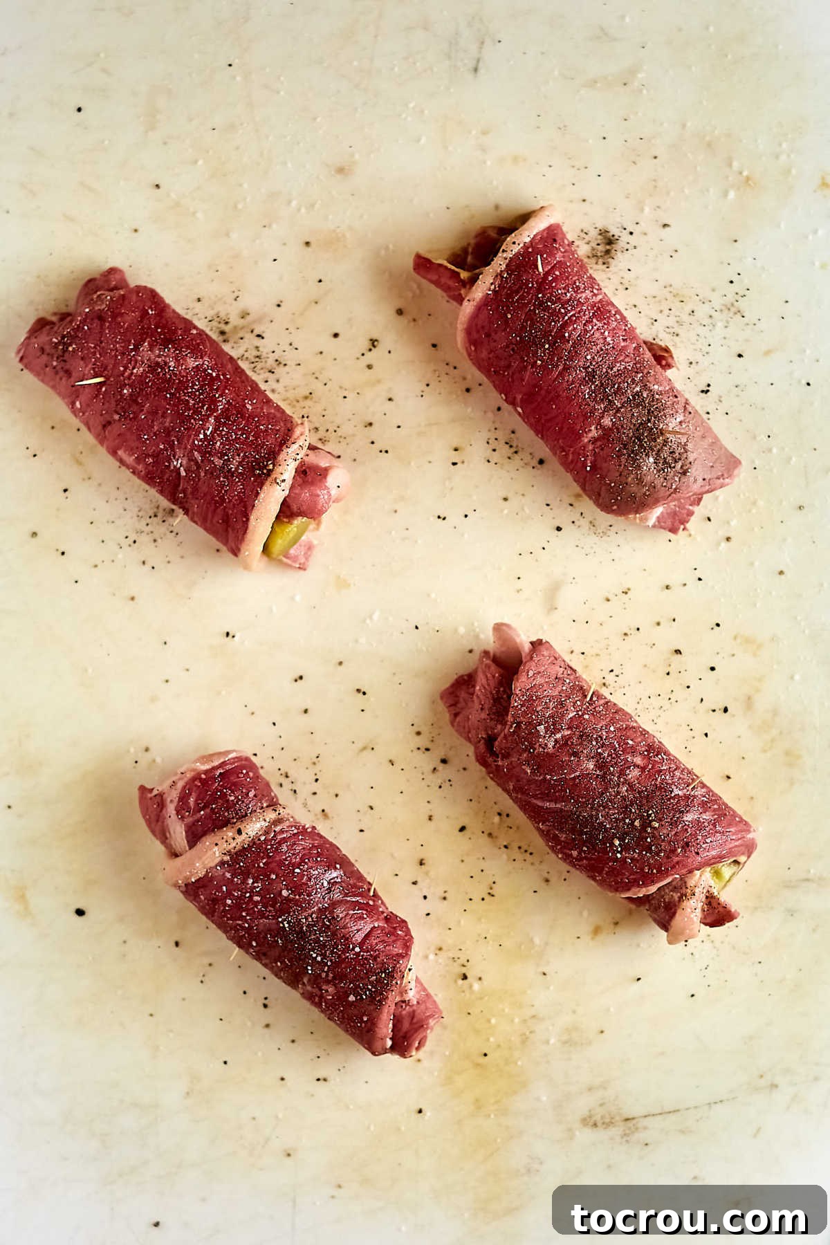 Steak wrapped around the pickle and bacon with toothpicks holding it in little packages. 