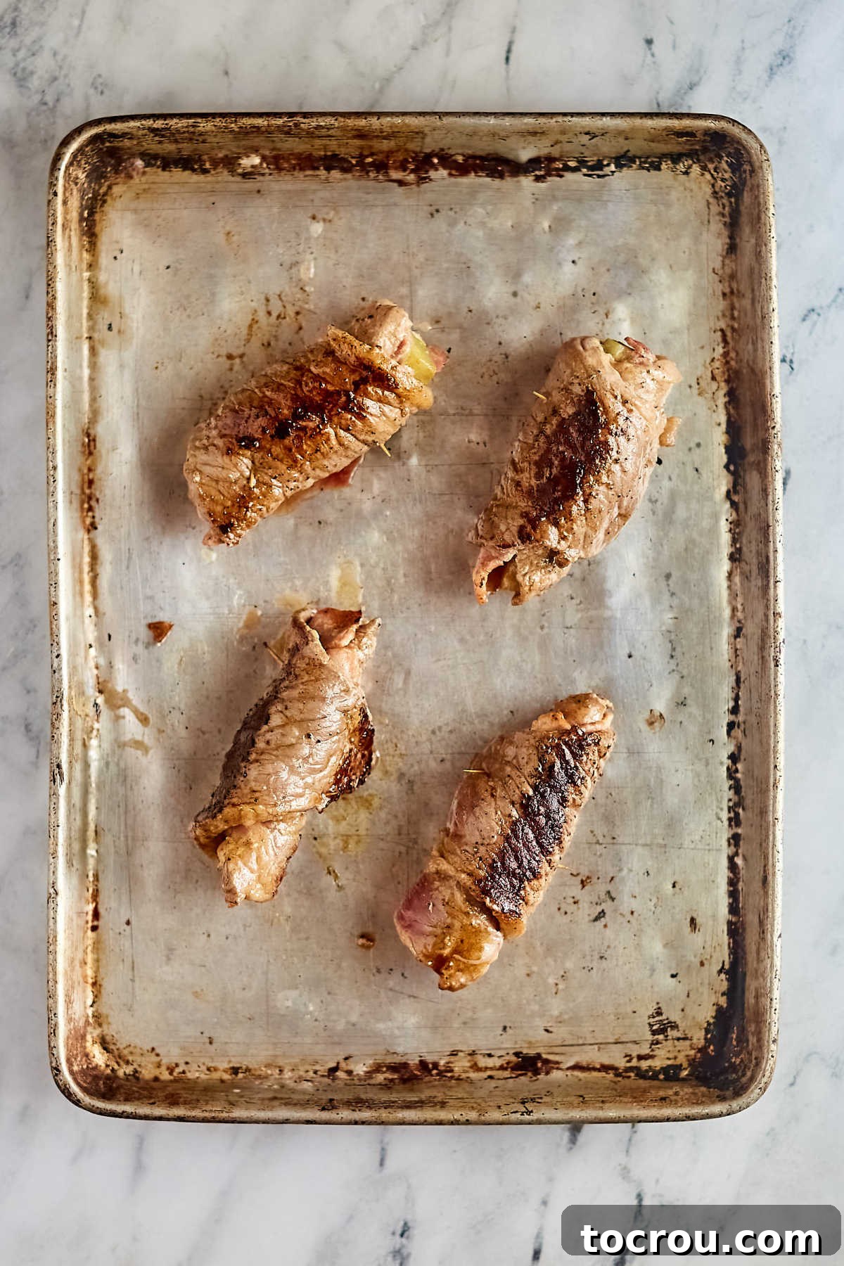 Beef rouladen after they have been browned in a skillet. 