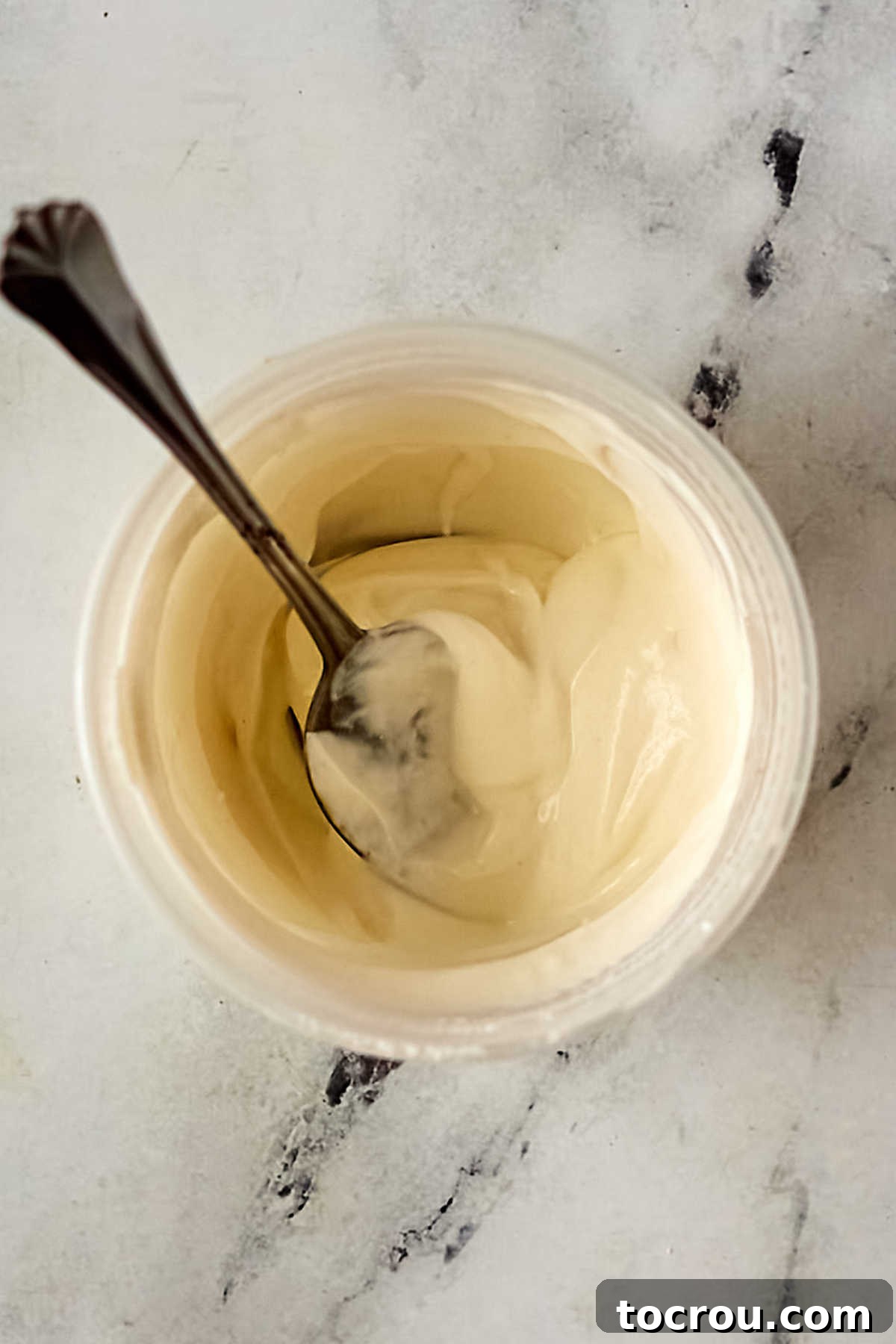 Small bowl of sour cream and flour mixed together, ready to be stirred into cooking juices to make gravy.