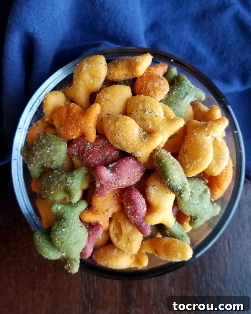 Overhead view of a bowl brimming with ranch-seasoned cheese crackers, perfectly coated and ready to bake.