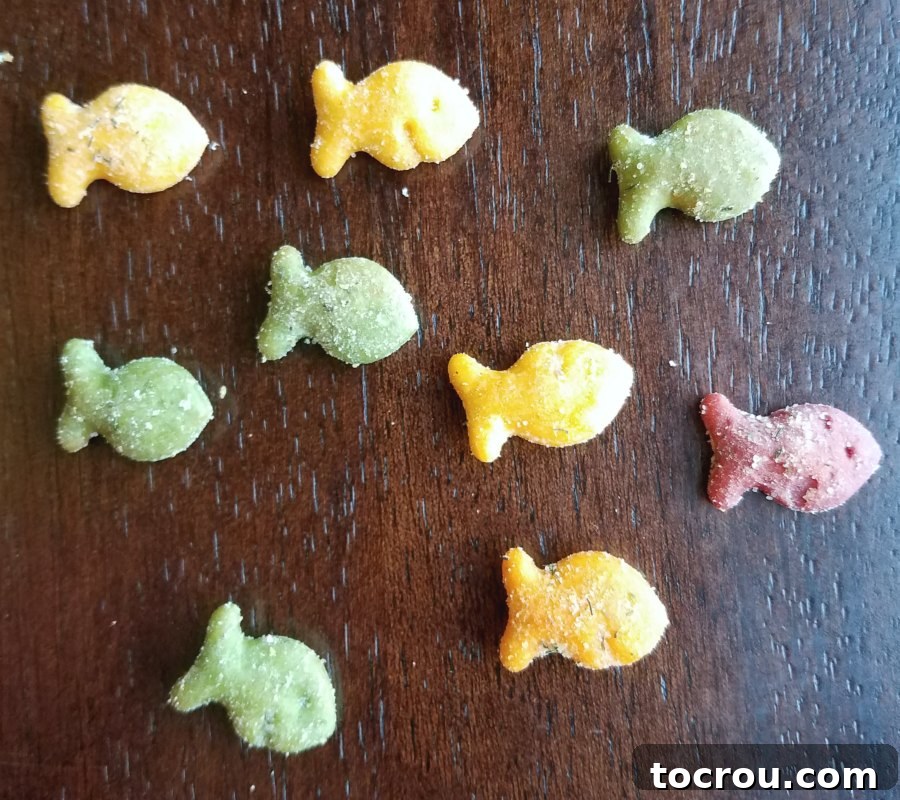 A playful scattering of cheddar fish crackers across a counter, ready for their flavor transformation.