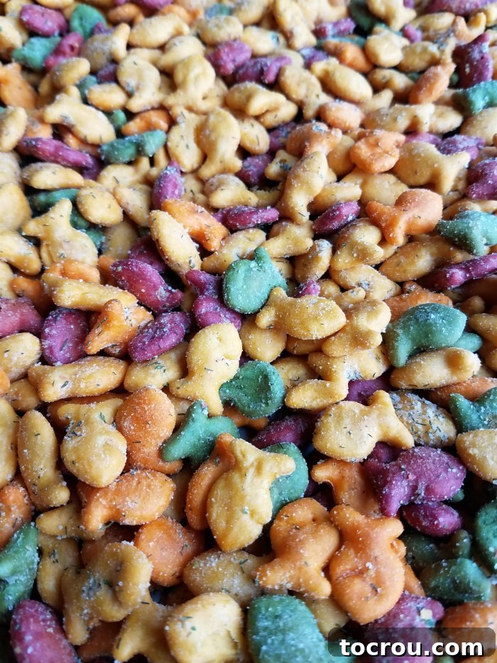 A generous pile of vibrantly colored Goldfish crackers, perfectly baked and coated in a dill and ranch spice mix.