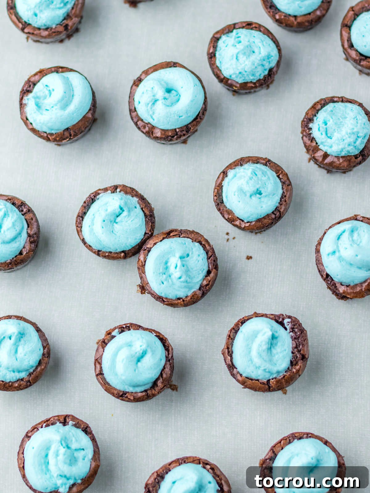 Blue Buttercream on Brownie Bites Dollop of blue buttercream in the center of each brownie bite.