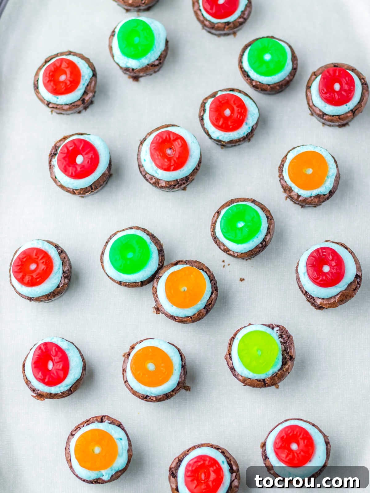 Gummy Lifesavers on Buttercream Gummy lifesaver rings placed on top of blue buttercream on brownie bites.
