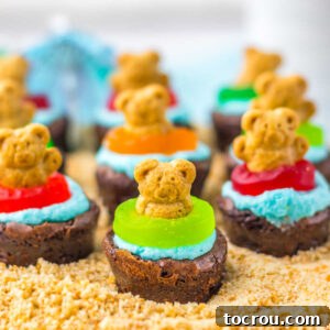 Mini brownies topped with blue buttercream for water, gummy lifesaver floats and teddy graham bears, ready to eat.