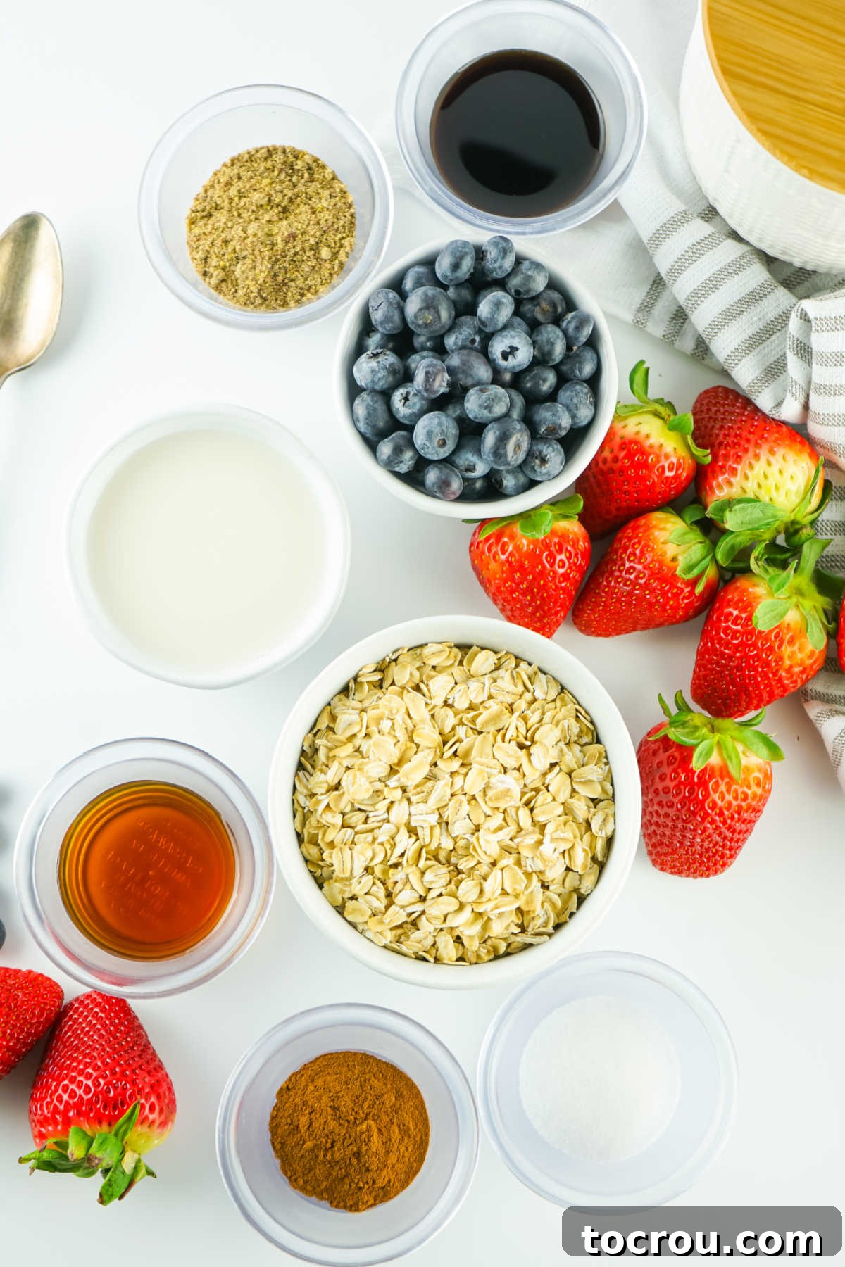 Velvety Overnight Oats 3 Ingredients including oatmeal, milk, flax seed, maple syrup, cinnamon, etc. ready to be made into overnight oats.