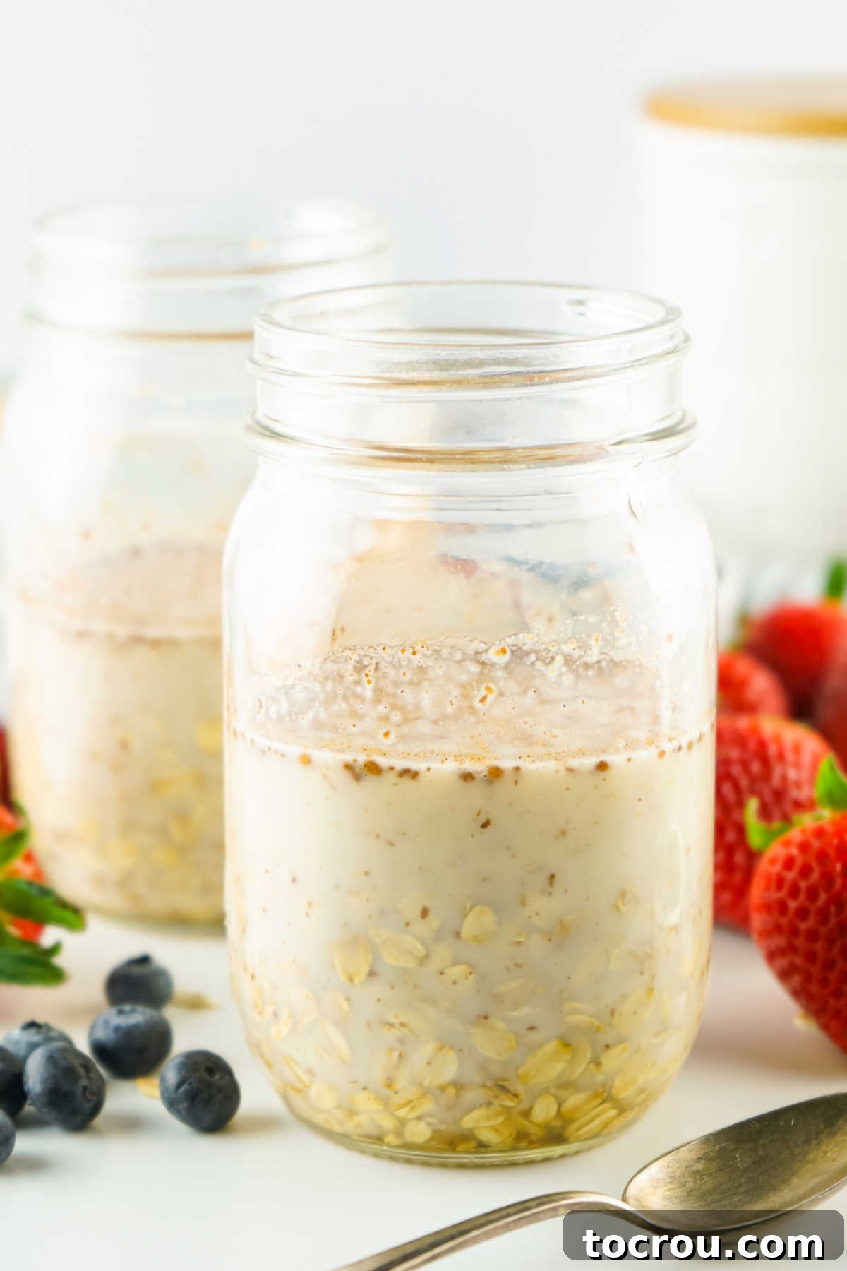 Velvety Overnight Oats 4 Jar after ingredients have been mixed together showing a lot of liquid before the oats absorb it.