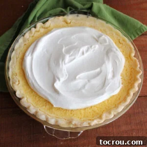 Homemade lemon pie topped with honey whipped cream.