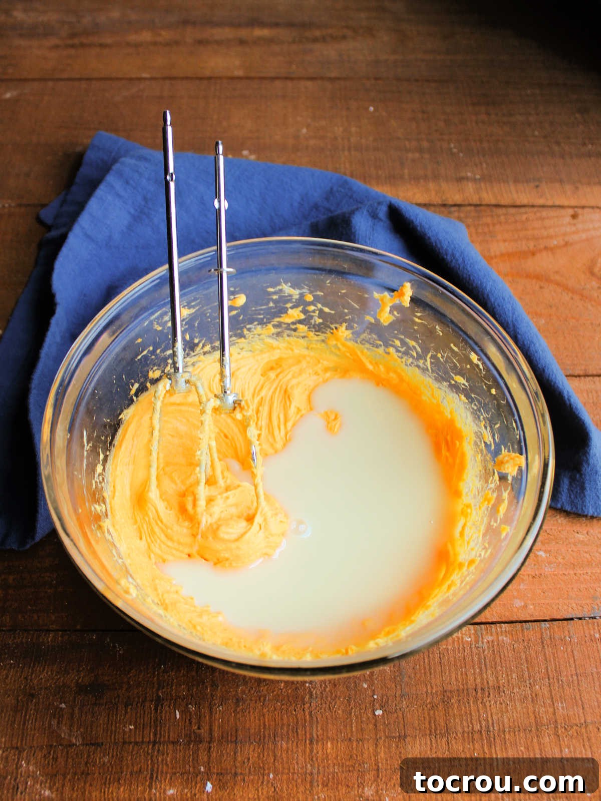 Golden Tang Delicacy 3 Mixing bowl with can of sweetened condensed milk being added to creamy tang and cream cheese mixture.