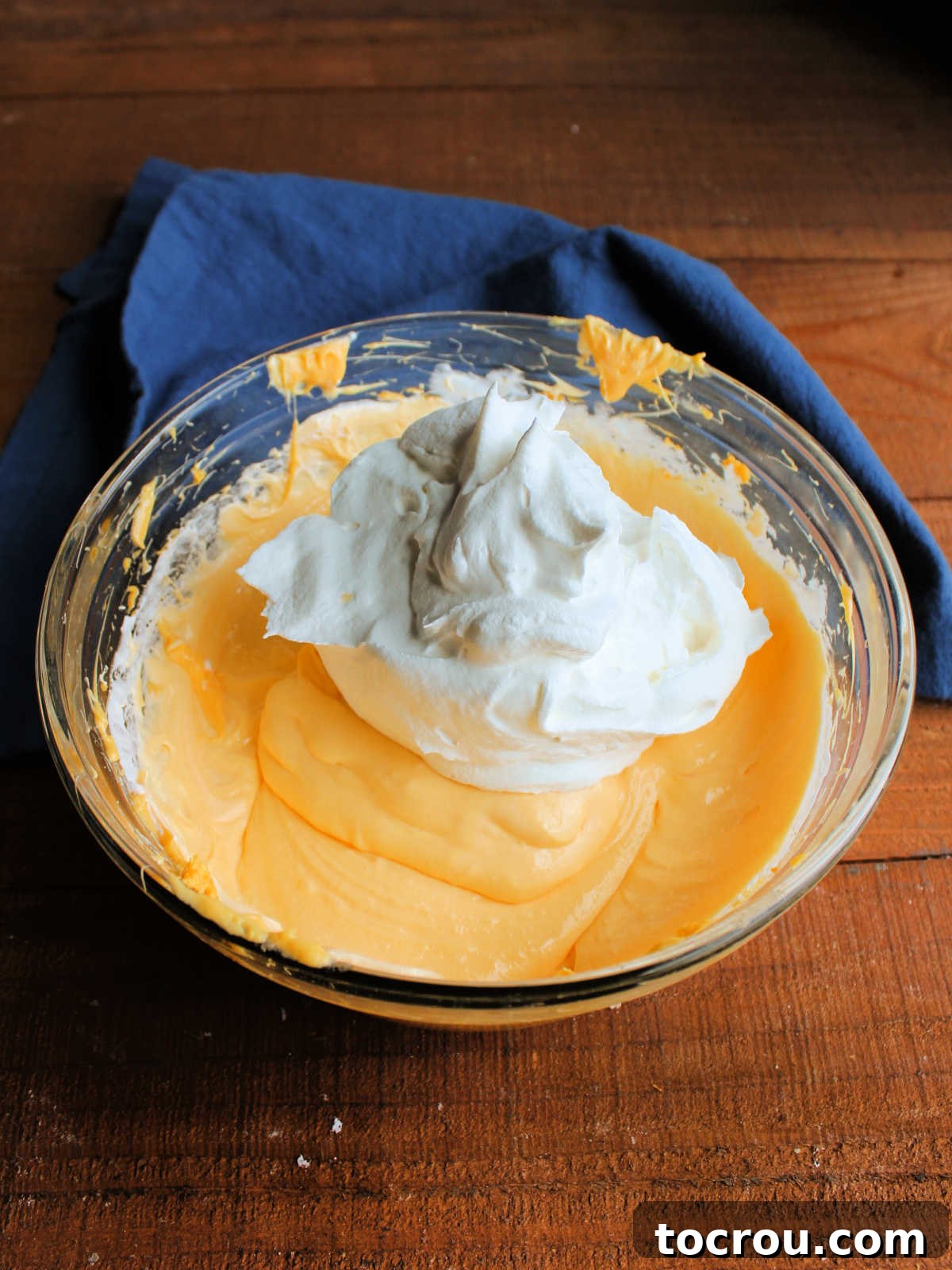 Golden Tang Delicacy 5 Adding Cool Whip to the filling mixture in the mixing bowl.