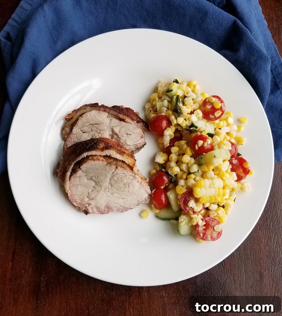 Corn salad served with bacon wrapped pork loin.