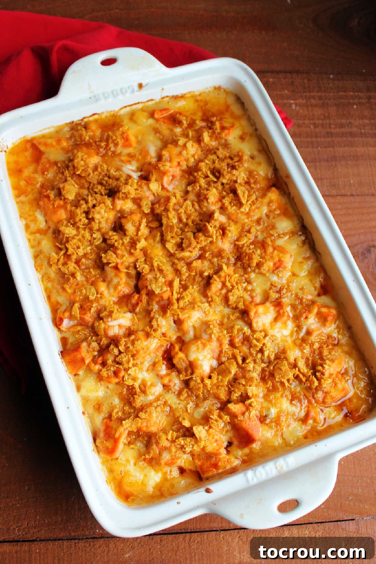 Freshly baked buffalo chicken and cheesy ranch potato casserole, golden brown and bubbling, straight from the oven and ready to be served.