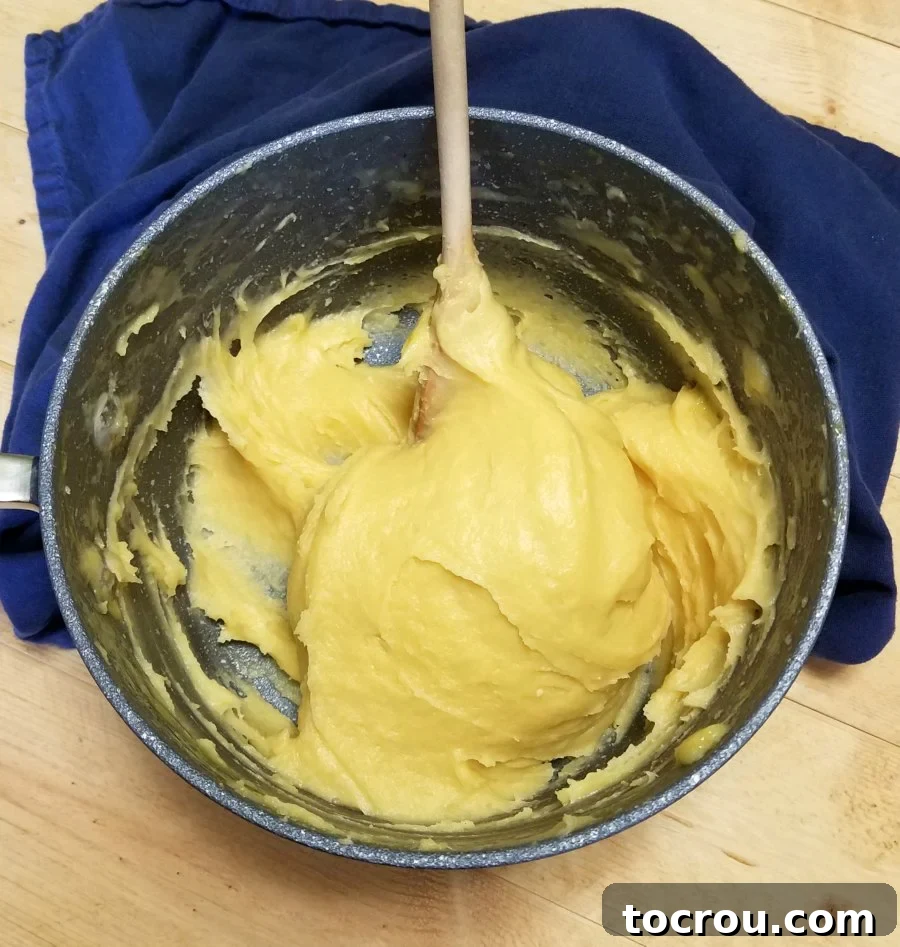 Savory Shrimp Profiterole Bites 5 choux dough in saucepan.