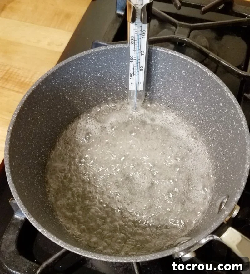 sugar syrup boiling in saucepan.