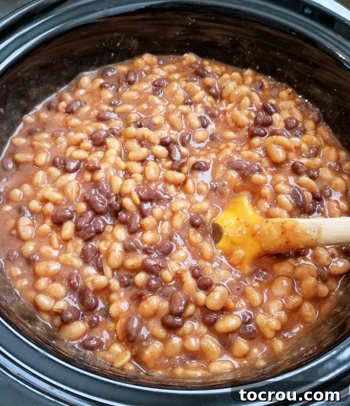 Smoky Slow Cooker Chuckwagon Beans 3 slow cooker full of thick bean mixture.
