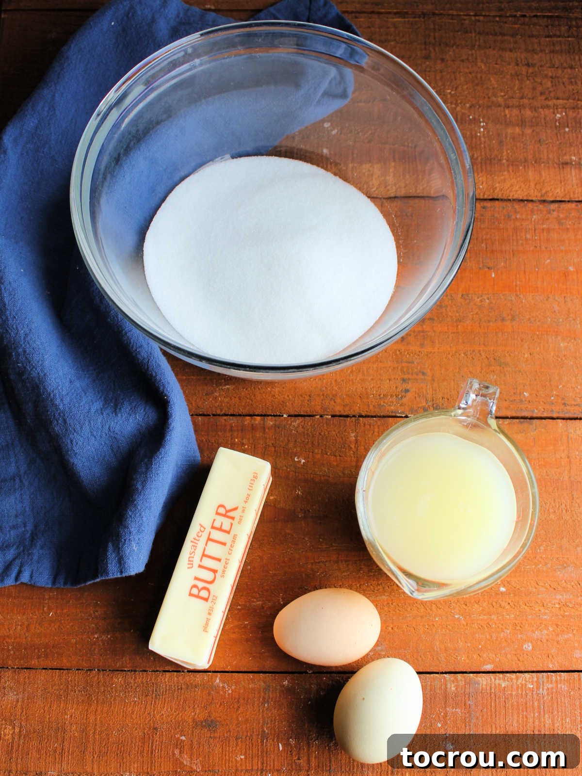 Lemon Curd Ingredients Ingredients for microwave lemon curd laid out: sugar, fresh lemon juice, butter, and eggs.