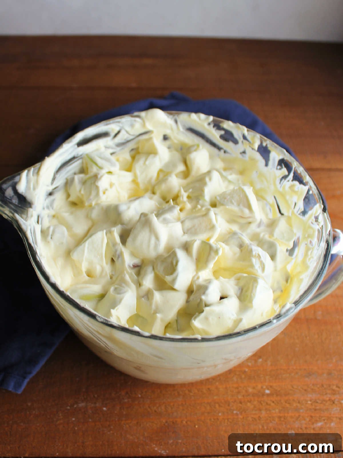 Decadent Apple Snickers Dessert 5 Mixing bowl filled with snickers salad, ready to be chilled until it is served.
