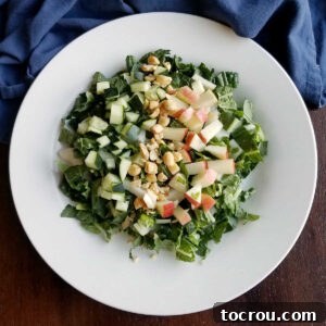 A vibrant bowl of Bok Choy Salad featuring crisp apples, roasted peanuts, and a creamy homemade peanut yogurt dressing.