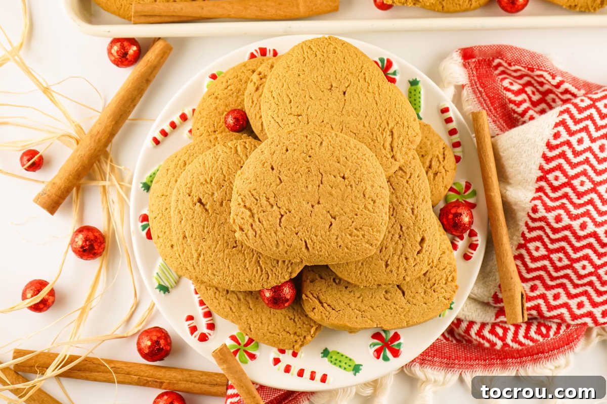 Christmas platter piled high with freshly baked gingersnap cookies with golden brown color from molasses and spices inside.