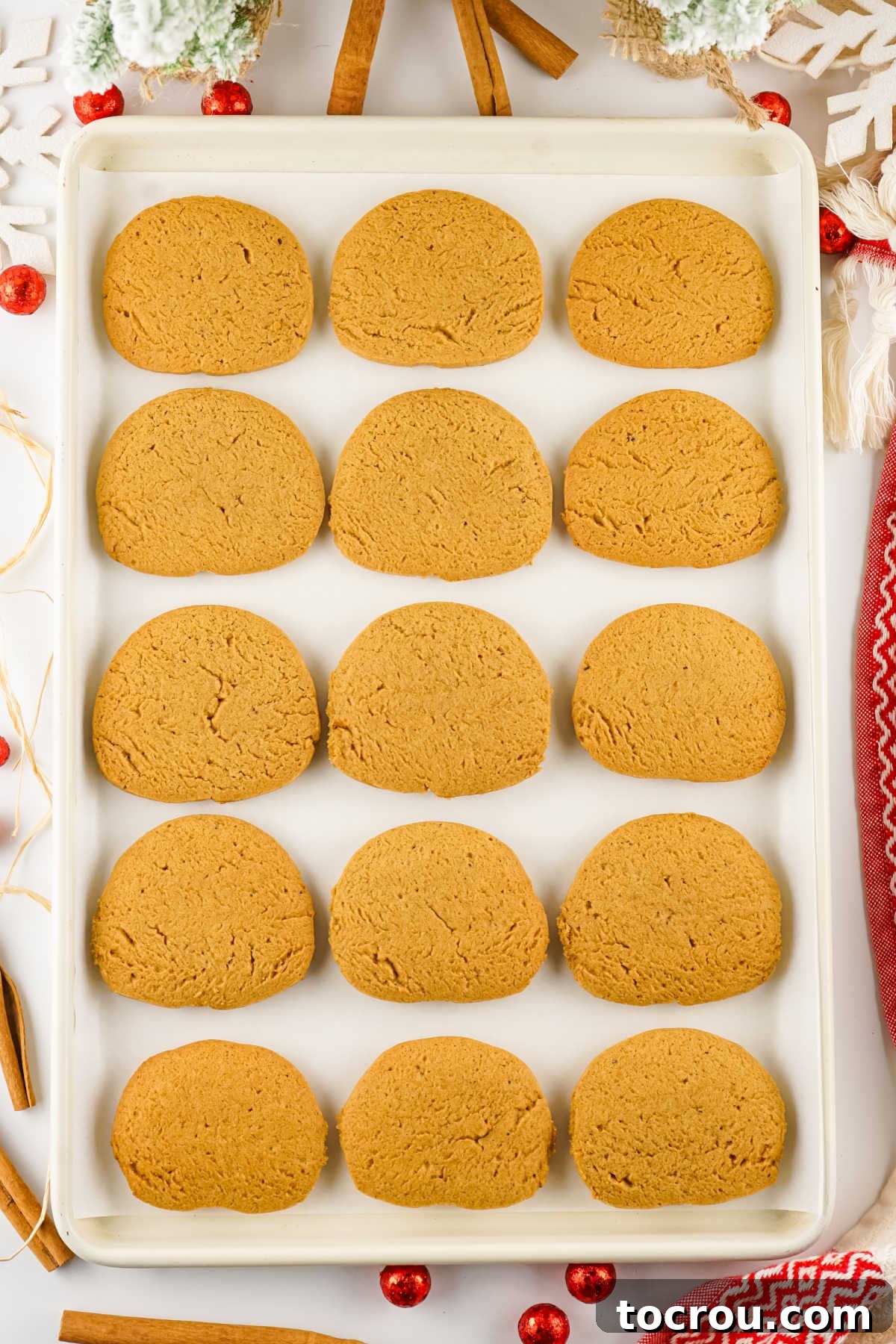 Cookies sheet filled with freshly baked slice and bake gingersnap cookies.