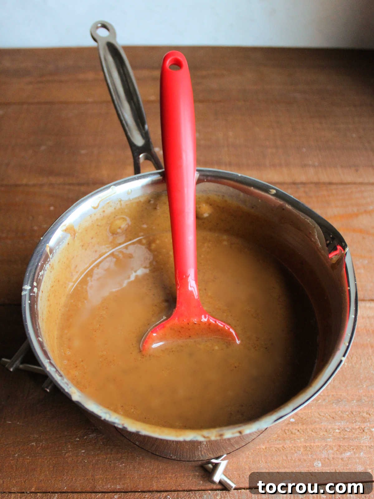 Saucepan with dark and thick caramel, ready to cool down to use. 